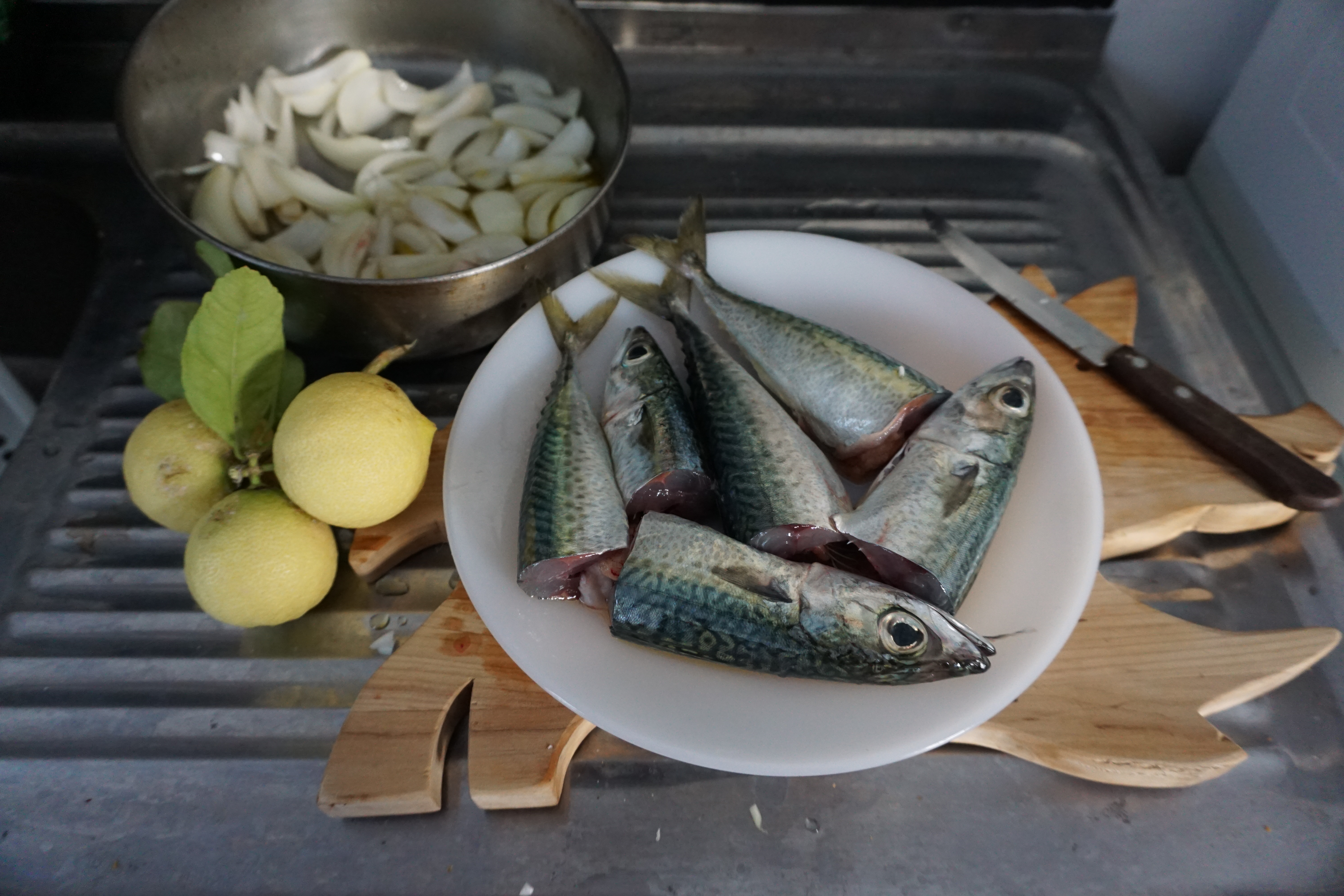 Preparing Fish With Lemon, Onions, Olive Oil And Oregano
