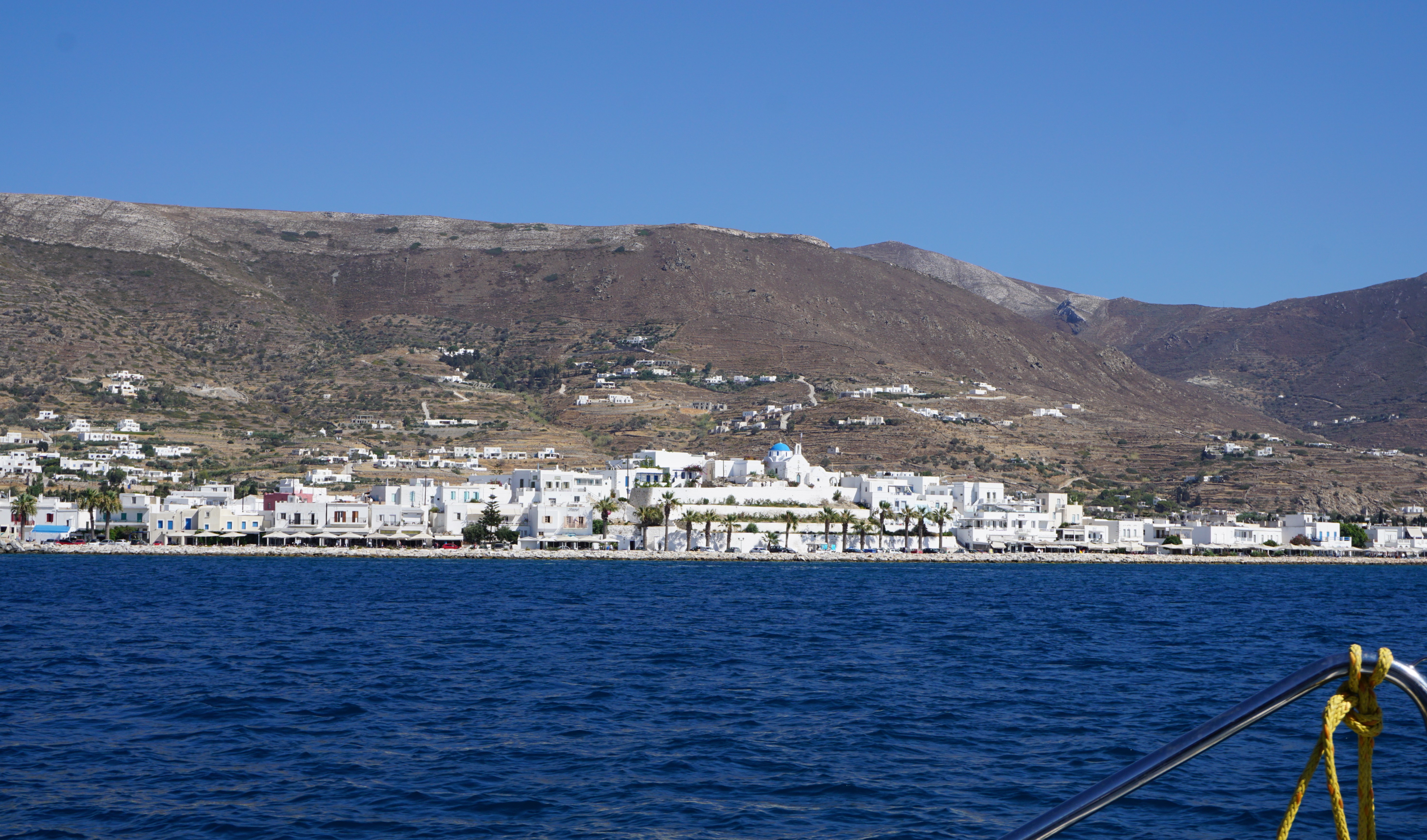 Paros With It's White Washed Buildings And Blue Domed Churches